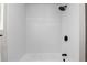 Bright shower featuring white tiling and sleek black fixtures at 4910 Alcott St, Denver, CO 80221