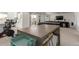 Versatile basement space with a kitchenette, game area, and comfortable seating, ideal for recreation and relaxation at 22773 E Narrowleaf Cir, Aurora, CO 80016