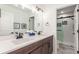 Bathroom featuring a double vanity, neutral walls and flooring with a shower and toilet behind a door at 22773 E Narrowleaf Cir, Aurora, CO 80016