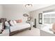 Bright bedroom featuring a full bed, large windows, and a decorative wall mirror at 22773 E Narrowleaf Cir, Aurora, CO 80016