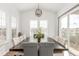 Formal dining room with a large table, stylish light fixture, and windows at 22773 E Narrowleaf Cir, Aurora, CO 80016