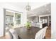 Open concept view of dining room with elegant table and chairs, and a glimpse into the kitchen and living areas at 22773 E Narrowleaf Cir, Aurora, CO 80016