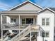 Aerial view of a house featuring a spacious two-story deck with outdoor seating and dining areas at 22773 E Narrowleaf Cir, Aurora, CO 80016