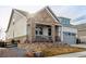 Charming home with stone accents, a cozy porch, and a well-manicured front yard at 22773 E Narrowleaf Cir, Aurora, CO 80016