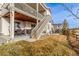 Two-story exterior view featuring the deck, patio, stairs and well-maintained lawn with neighborhood views at 22773 E Narrowleaf Cir, Aurora, CO 80016