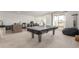 Expansive game room featuring a ping pong table and access to an outdoor space, perfect for entertainment at 22773 E Narrowleaf Cir, Aurora, CO 80016