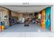 Well-organized garage equipped with epoxy flooring, storage cabinets, and space for multiple vehicles at 22773 E Narrowleaf Cir, Aurora, CO 80016