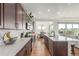 Spacious kitchen featuring dark wood cabinets, stainless steel appliances, and white countertops at 22773 E Narrowleaf Cir, Aurora, CO 80016