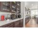 Kitchen details featuring appliances, sleek white backsplash, quartz countertops, and dark wood cabinetry at 22773 E Narrowleaf Cir, Aurora, CO 80016