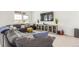 Spacious living room with a large sectional sofa, entertainment center, and ample natural light at 22773 E Narrowleaf Cir, Aurora, CO 80016