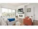 Bright living room with modern fireplace, hardwood floors, and sliding glass doors to patio at 22773 E Narrowleaf Cir, Aurora, CO 80016