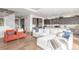 Open-concept living room flows into the kitchen with hardwood floors and bright lighting at 22773 E Narrowleaf Cir, Aurora, CO 80016