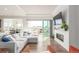 Bright living room featuring a fireplace, hardwood floors, and sliding doors to the patio at 22773 E Narrowleaf Cir, Aurora, CO 80016