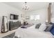 Bright main bedroom featuring a grey dresser, carpet, and a king bed with throw blanket and decorative pillows at 22773 E Narrowleaf Cir, Aurora, CO 80016