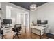 Bright office space featuring multiple desks, modern lighting and hardwood floors at 22773 E Narrowleaf Cir, Aurora, CO 80016