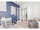 Stylish office area featuring french doors, a blue accent wall, and comfortable seating, creating an inspiring workspace at 22773 E Narrowleaf Cir, Aurora, CO 80016