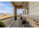 Charming front porch with stone columns, a cozy bench, and a view of the neighborhood at 22773 E Narrowleaf Cir, Aurora, CO 80016