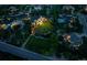 Aerial view of a luxurious estate at dusk, featuring a large home, manicured grounds, and a serene setting at 8717 Ridgepoint Dr, Castle Pines, CO 80108