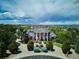 Grand estate with circular driveway and lush landscaping in an established neighborhood at 8717 Ridgepoint Dr, Castle Pines, CO 80108