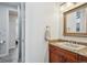 Bathroom with granite countertops, decorative mirror, and tile flooring at 8717 Ridgepoint Dr, Castle Pines, CO 80108