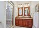 Elegant bathroom features double sinks, granite countertops, and a separate glass enclosed shower at 8717 Ridgepoint Dr, Castle Pines, CO 80108