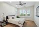 Well-lit bedroom featuring a ceiling fan, large windows, and a comfortable bed at 8717 Ridgepoint Dr, Castle Pines, CO 80108