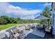 Outdoor deck with seating and umbrella overlooking a lush green yard and trees at 8717 Ridgepoint Dr, Castle Pines, CO 80108
