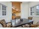 Dining room with hardwood floors, decorative chairs, and view into gymnasium at 8717 Ridgepoint Dr, Castle Pines, CO 80108