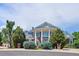 Stunning two-story brick home with white columns and manicured landscaping at 8717 Ridgepoint Dr, Castle Pines, CO 80108
