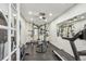 Home gym with mirrored wall, ceiling fan, and plenty of workout equipment at 8717 Ridgepoint Dr, Castle Pines, CO 80108