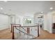 Bright hallway featuring wood banister, chandelier, and access to multiple rooms at 8717 Ridgepoint Dr, Castle Pines, CO 80108