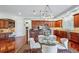 Spacious kitchen with cherry cabinets, large island, and an adjacent breakfast nook with a glass table and seating at 8717 Ridgepoint Dr, Castle Pines, CO 80108