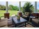 Inviting porch area with comfortable seating, a decorative table, and views of the lush green landscape at 8717 Ridgepoint Dr, Castle Pines, CO 80108