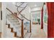Elegant staircase with a wood banister and access to a living area and hallway at 8717 Ridgepoint Dr, Castle Pines, CO 80108