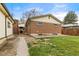 A brick home's back exterior featuring a concrete patio, small yard and back access entry way at 1327 E 108Th Pl, Northglenn, CO 80233