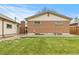 The home's back exterior shows a brick home with a concrete patio and an adjacent building at 1327 E 108Th Pl, Northglenn, CO 80233