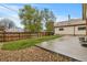 A backyard with a small concrete patio and an adjacent lawn featuring a well-maintained fence at 1327 E 108Th Pl, Northglenn, CO 80233