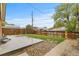 Fenced backyard with a concrete patio, grass, and rock landscaping provides a relaxing outdoor space at 1327 E 108Th Pl, Northglenn, CO 80233