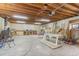The basement has exposed wood beams, storage, and a workspace, offering potential for customization at 1327 E 108Th Pl, Northglenn, CO 80233