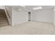Finished basement with carpet, white walls, and access to a stairway and storage at 1327 E 108Th Pl, Northglenn, CO 80233