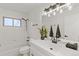 This bathroom features a modern vanity, bright lighting, and a shower-tub combo at 1327 E 108Th Pl, Northglenn, CO 80233