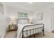 This bedroom features a metal bed frame, neutral color palette, and natural light at 1327 E 108Th Pl, Northglenn, CO 80233