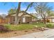 A brick home's exterior, including a lush front lawn, blooming flower beds and mature trees at 1327 E 108Th Pl, Northglenn, CO 80233