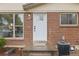 Charming brick home featuring a front door with glass panels and neat landscaping for great curb appeal at 1327 E 108Th Pl, Northglenn, CO 80233