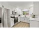 Modern kitchen with white cabinets, stainless steel appliances, and ample countertop space at 1327 E 108Th Pl, Northglenn, CO 80233