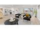 Spacious open-concept living area featuring modern furniture, white kitchen and large windows at 1327 E 108Th Pl, Northglenn, CO 80233