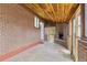 Enclosed patio featuring a brick fireplace, wood paneled ceiling, and exterior access at 1327 E 108Th Pl, Northglenn, CO 80233
