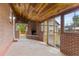 Enclosed patio featuring a brick fireplace, wood paneled ceiling, and exterior access at 1327 E 108Th Pl, Northglenn, CO 80233