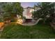 Beautiful backyard features a spacious deck, mature trees, and a well-maintained lawn at 15565 Flowerhill Cir, Parker, CO 80134