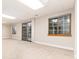Spacious carpeted basement featuring a sliding glass door and large windows for ample natural light at 15565 Flowerhill Cir, Parker, CO 80134